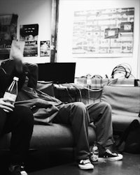 two men sitting on a couch