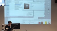 a man standing in front of a projection screen
