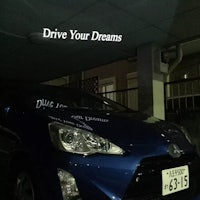 a blue toyota prius parked in a garage with the words drive your dreams